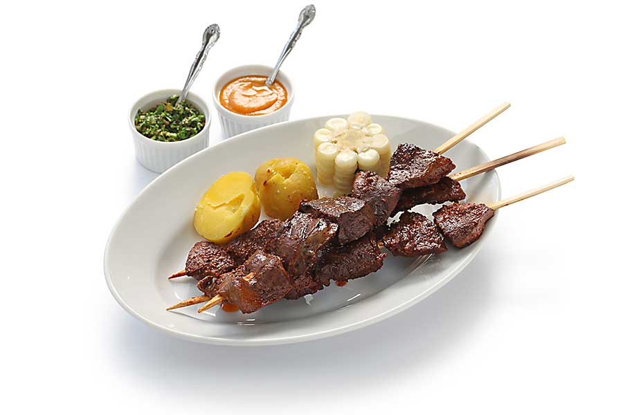 Anticuchos, Peruvian cuisine, grilled skewered beef heart meat with boiled potato and white corn