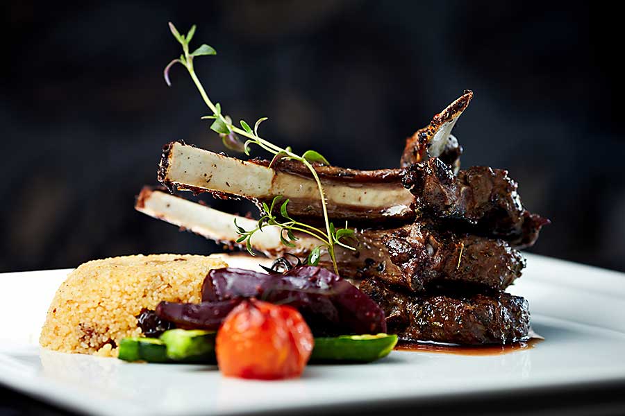 Morrocan food - grilled lamb carre with warm couscous salad, roasted vegetables