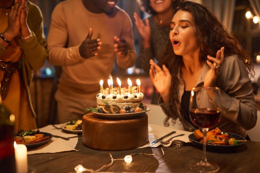 a birthday lady blowing off candles