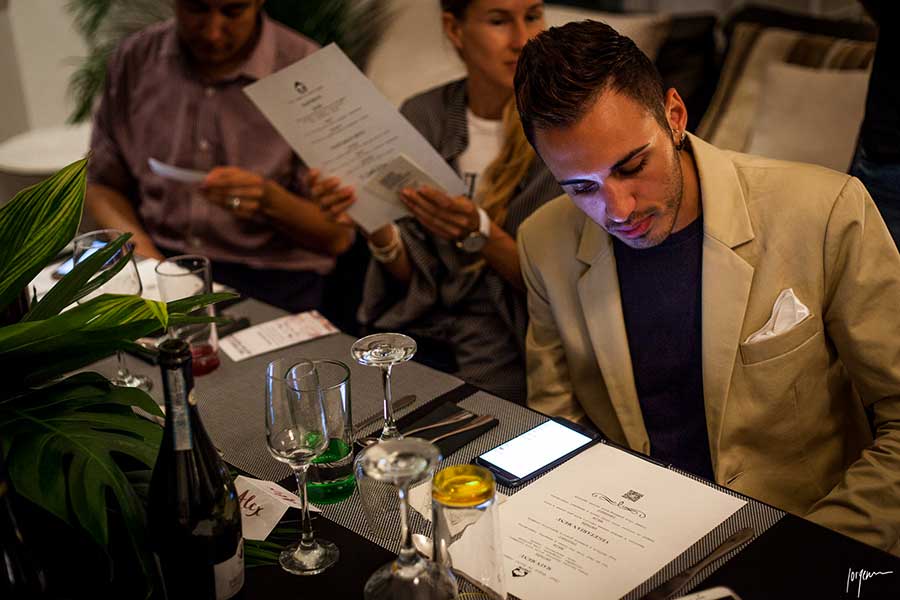 a male guest is looking at a menu at a CHEIFN dinner