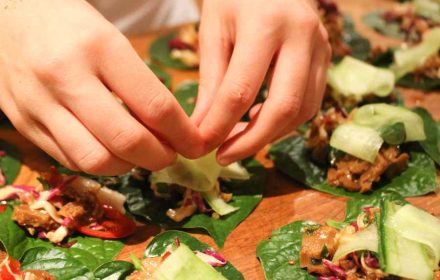 Sydney North Shore Private Chef Valeria Boselli plating a vegan san choy bao, edible flowers, mint leaves, chilli, vegan pulled pork jackfruit