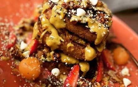 Chef Ralph Cazenave Bey French Toast Layaered With Pumpkin Chai Cream, Fried Plantains, Topped With Strawberries, Candied Brazil Nuts, Dates, Cacao Chips, Melon Balls, And Hemp Seeds