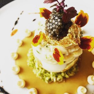 a well presented dish with gold leaf