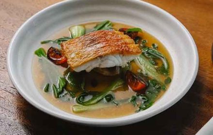 Chef William Lochetto Signature mamas soup with local snapper, aromatic broth, and fresh greens