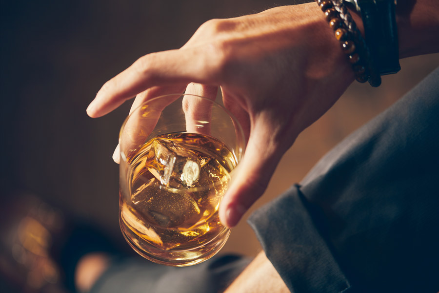 high-angle-closeup-shot-male-holding-glass-whiskey