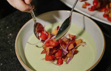 Chef Betty COquillard refreshing plum and cherry tomatoes salad on a basil mozzarella cream