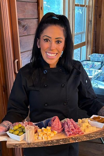 Profile Photo of Chef Michelle Reha holding an antipasti platter