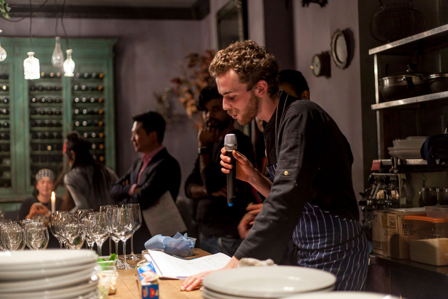 a chef is giving a talk to a crowd