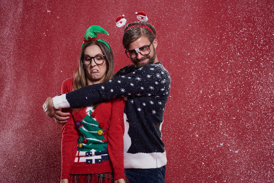 a boy and a girl with wired christmas clothes